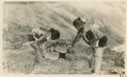 Image of Mother showing daughter how to set a stone fox-trap